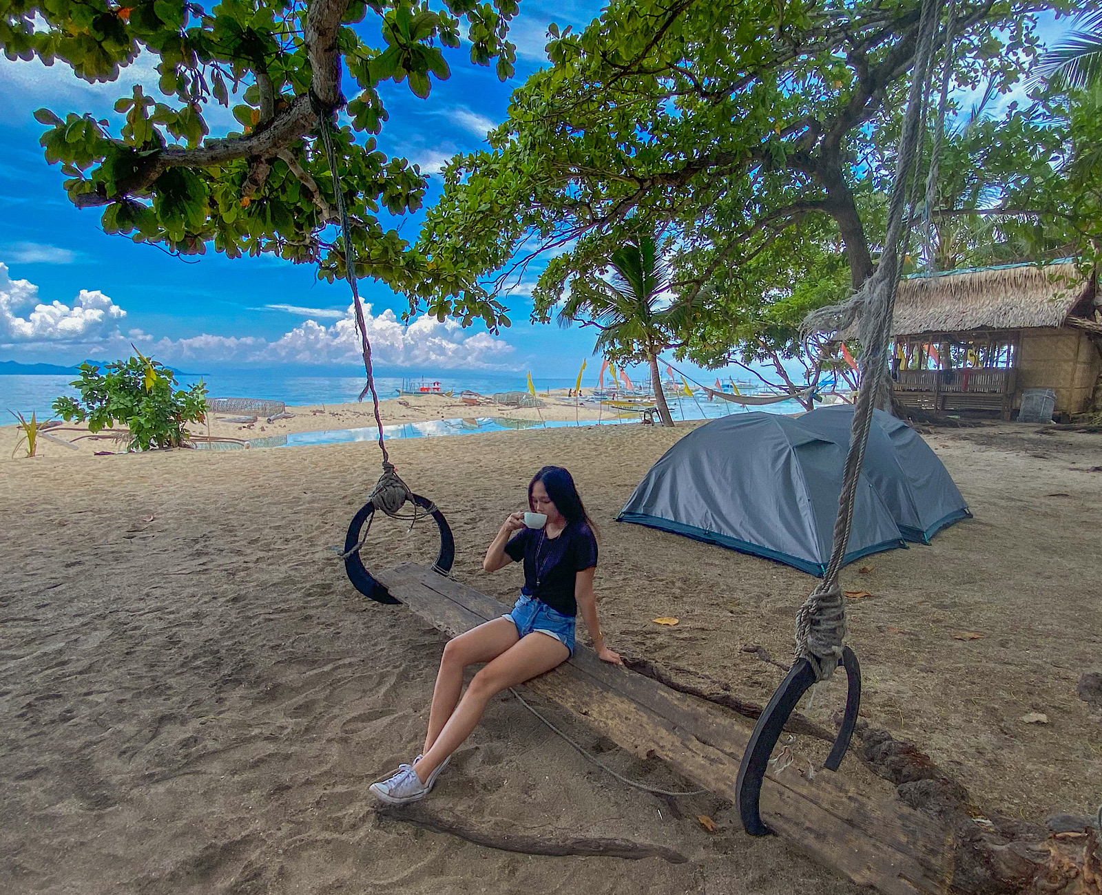 girl drinking coffee beach